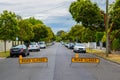 Road Closed yellow signs blocking residential street.