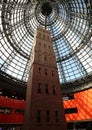 Historical Coop`s  Shot Tower, encased by the Melbourne Central 84 m-high conical glass roof. Royalty Free Stock Photo