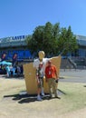 Rod Laver posing for picture with tennis fan in front of his statue at Australian tennis center in Melbourne, Australia.