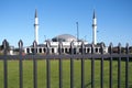 New build Mosque of the Keysborough Turkish Islamic and Cultural Centre behind a tall steel fence at a road near Melbourne
