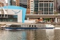 Aquarium building behind Yarra river with cruise boat downtown Melbourne, Australia