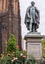 O Connell bronze statue with brown church wall, Melbourne, Australia