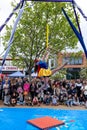 Acrobat performing in front of large crowd.