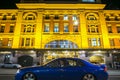 Melbourne, Australia - October 17,2013 night photography of a blue car with men pass in front of classic building