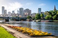 Melbourne buildings skyline with Yarra river view and yellow kayak boats on the riverbank in Melbourne Victoria Australia