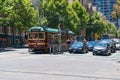 Melbourne CBD road with historic tramway and modern cars on the intersection