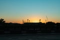 Melbourne Cricket Ground stadium silhouetted by bright rising morning sun