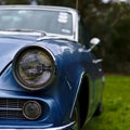 Close up view of headlight of blue vintage car