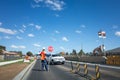 Melbourne, VIC/Australia-Sept 21st 2020: A traffic controller directing the flow of vehicles by a holding a stop/slow bat