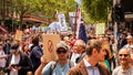 Melbourne, Victoria Australia - November 20 2021: Thousands of people fill the streets holding political signs on Bourke Street