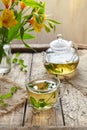 Melissa tea in cup, teapot with fresh leaves and flowers Royalty Free Stock Photo