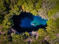 Melissani Cave Kefalonia viewed from above with tourists entering the cave by boat Royalty Free Stock Photo