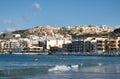 Mellieha, Malta built up on a hilll across the water