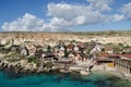 Mellieha, Malta 30 december 2018 - Wooden colorful houses in Popeye Village movie set view from anchor bay Royalty Free Stock Photo