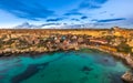 Mellieha, Malta - The famous Popeye Village at Anchor Bay at sunset Royalty Free Stock Photo