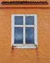 Rustic Window on Bright Orange Stucco Wall Royalty Free Stock Photo