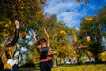 Mellow autumn. Two girls are students cheerfully spend time in the city park. Royalty Free Stock Photo