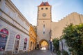 Melnik, Czech Republic - 29.07.2020: City landscape, an old city street at sunset with numerous cafes and the high clock tower,