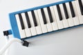 Melodica prepared to play on the table with blow tube Royalty Free Stock Photo