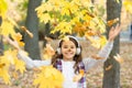 Melody of autumn. Schoolgirl listening modern headphones. Headphones technology. Falling leaves. Happy little girl wear