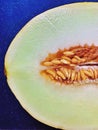 melon cut in half, yellow melon, juicy fruit, lots of seeds in melon cut, cantaloupe melon Royalty Free Stock Photo