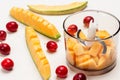 Melon cut into pieces in blender jar. Sliced melon and small red apples on table Royalty Free Stock Photo