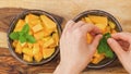 Melon fruit salad with mint leaves close up in bowls, woman hands Royalty Free Stock Photo