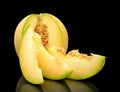 Melon galia notched with slices isolated black in studio