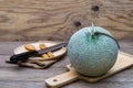 Melon and knife on cutting board Royalty Free Stock Photo