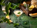 Melon margarita cocktail with mint in glass on dark green ceramic tile background Royalty Free Stock Photo