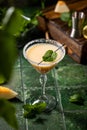 Melon margarita cocktail with mint in glass on dark green ceramic tile background Royalty Free Stock Photo