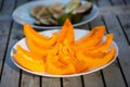 Melon with parma ham on garden table