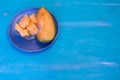 Melon pieces, on white table with blue plate Royalty Free Stock Photo