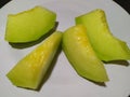 melon slices on a plate with a black background Royalty Free Stock Photo