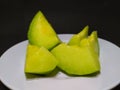 melon slices on a plate with a black background Royalty Free Stock Photo