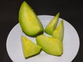 melon slices on a plate with a black background Royalty Free Stock Photo