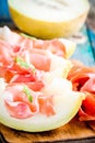 Melon with thin slices of prosciutto