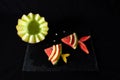 Melon and watermelon in the shape of a fish, on a black background Royalty Free Stock Photo