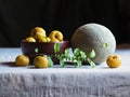 Melon and yellow quinces on a dark background