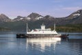 The ferry Narvik embarks on its journey across a placid northern fjord, reflecting on the mirror-like surface Royalty Free Stock Photo