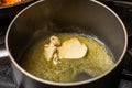 Melt the butter in a saucepan. The initial stage of preparing the sauce Royalty Free Stock Photo