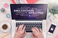 Meltdown and spectre threat concept on top view laptop screen with mans hands on office desk Royalty Free Stock Photo