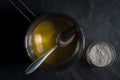 Melted butter in a ladle and a bowl of flour Royalty Free Stock Photo