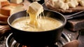 Melted cheese fondue being lifted on a fork, showcasing the creamy texture against a backdrop of artisanal cheeses