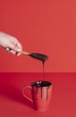 Melted chocolate dripping from wooden spoon. Mug with chocolate Royalty Free Stock Photo