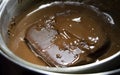 Melted chocolate in pan under a water bath. Making hot chocolate at home in your own kitchen Royalty Free Stock Photo