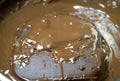 Melted chocolate in pan under a water bath. Making hot chocolate at home in your own kitchen Royalty Free Stock Photo