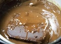 Melted chocolate in pan under a water bath. Making hot chocolate at home in your own kitchen Royalty Free Stock Photo