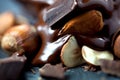 Melted chocolate pouring into a piece of chocolate bars on a table. Royalty Free Stock Photo