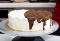 Melted chocolate spreads over cream cake Royalty Free Stock Photo